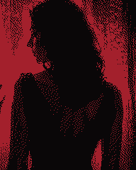 Silhouette of a woman with long hair seen from behind against red glass